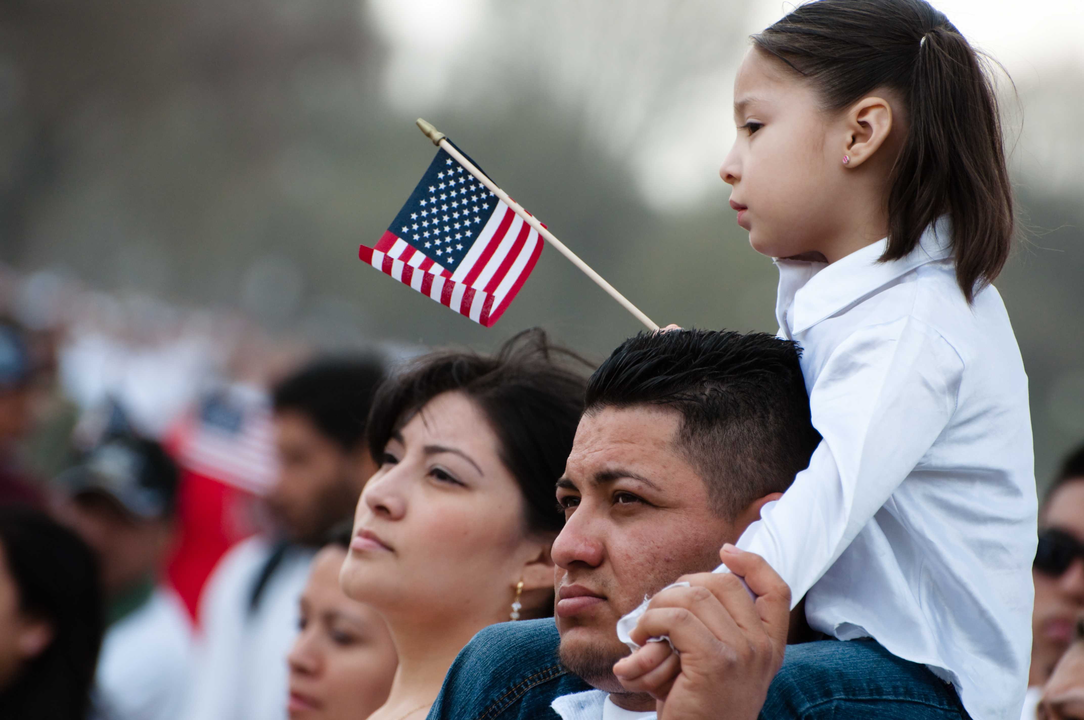 
            People wave American flags